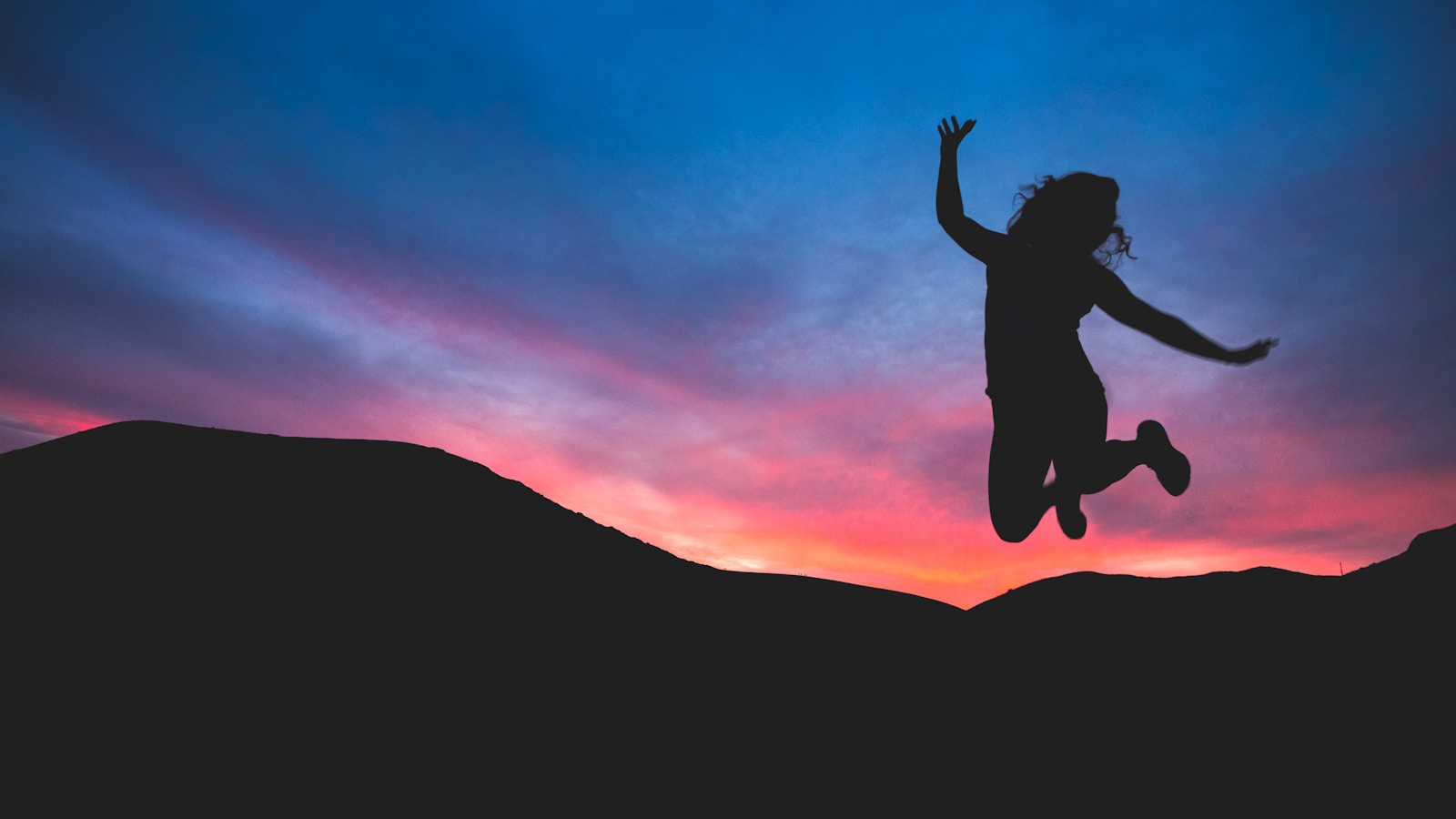 Photo by Austin Schmid silhouette of person jumping during dawn
